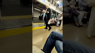 Japanese man tries to drag foreigner off the train for being loud and drinking.