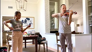My violin teacher is playing on my violin and testing a new bow