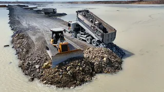Large-scale road expansion is made possible by advanced rock mixtures, dump trucks, bulldozer D60P