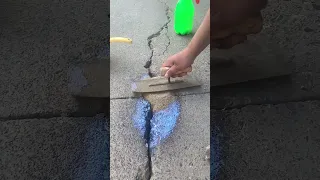 Pavement repair Pockmarked surface white pebbles falling off sand turning