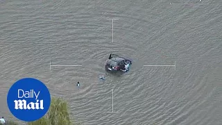 Police rescue woman from sinking car after she drove into river - Daily Mail