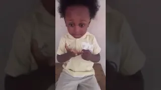 A very smart African kid telling countries capital.