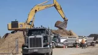 Excavator video: loading trucks on busy construction site (Kids video)