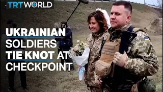 Ukrainian soldiers exchange rings at Kiev checkpoint