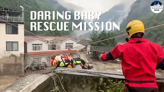Thrilling MOMENT stranded baby rescued by rope slide in SW China's flooding