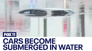 California rain: Long Beach cars submerged in flood waters