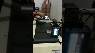 MRP printing machine with conveyor belt.