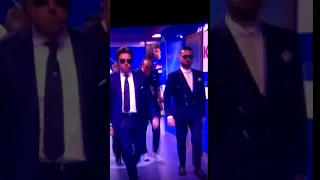 Chelsea's new manager Maurizio Sarri walking with security guards while smoking a cigarette.