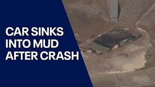 Car sinks into mud near Desert Sky Mall