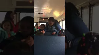 They are fighting on the school bus