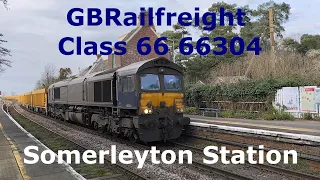 Class 66 GBRf 66304 Network Rail Ballast Train passing through rural Somerleyton Railway Station.