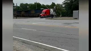 Wild video of a train crashing into a stalled tractor trailer with driver standing just feet away
