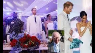 Awkward moment Harry and Meghan stand for God Save The King at Nigerian charity event