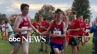 High School Runner Helps Fellow Runner Finish at Meet