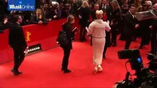 Tilda Swinton and George Clooney share a joke on red carpet