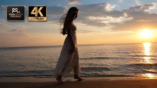 Woman in sundress walking on the beach at sunset - Royalty Free by YOUR STOCK FOOTAGE