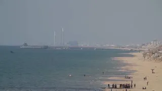 Palestinians in central Gaza wait for aid trucks to roll off pier built by US