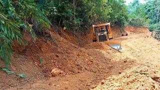 Excellent work of Caterpillar D6R XL bulldozer operator working to clean plantation road or mountain