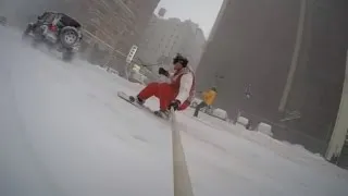 Watch This Daredevil Snowboard Through New York City Being Pulled by a Car