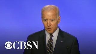 Biden opens speech with joke about hugging