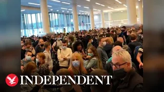 JFK Airport passengers stuck in two-hour queues as US lifts travel ban