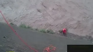 Two men dramatically rescued from floodwaters in China