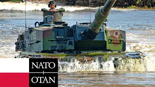 Tanks and armored vehicles of NATO allies cross a river during an exercise in Poland.
