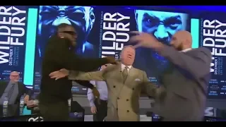 DEONTAY WILDER SHOVES TYSON FURY AFTER BEING ASKED TO SPAR IN MIDDLE OF PRESS CONFERENCE