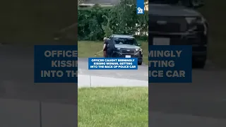 Officer caught seemingly kissing woman, getting into back of police car