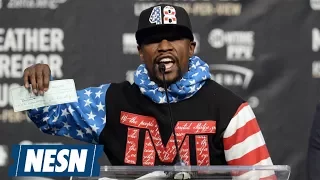 Floyd Mayweather Shows Off $100,000,000 Check In McGregor's Face