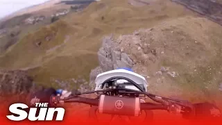 Dirt biker rides off 40ft cliff and survives (Wales)