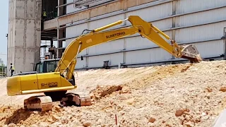 Excavator Trimming Soil Slope At Bottom - Sumitomo SH200