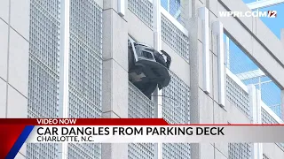 Video Now: Car dangles from parking deck in NC