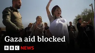 Israeli protesters block food convoys for starving civilians in Gaza | BBC News