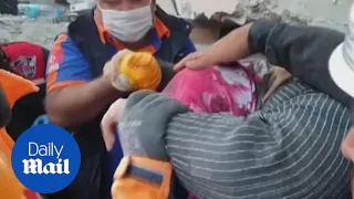 Turkey earthquake: Rescue workers pull elderly woman out of rubble