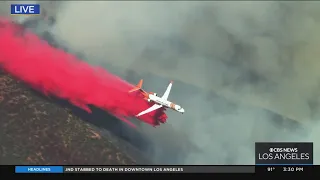 Planes drop fire retardant to stop the East Fire from spreading