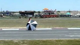 Umbrella on track nearly killing motorcycle racers.