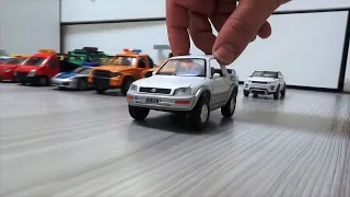 Models of various cars are driving on the floor