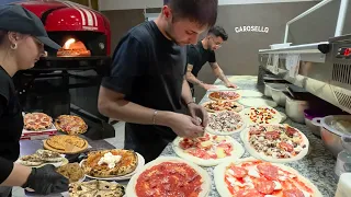 What a sight! Pizzas and Panuozzi fly out of oven by young Pizzaiolos.Pizzeria'Carosello',None,Italy