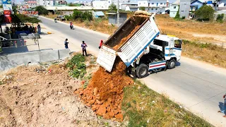 First Starting opening new Project Land filling up Dump truck T5 unloading stone, bulldozer pushing.