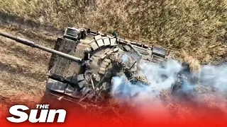 Russian tanks are destroyed as Ukraine drops grenades through the open hatch