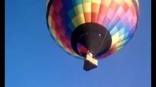 Hot air balloon taking off from field by our house