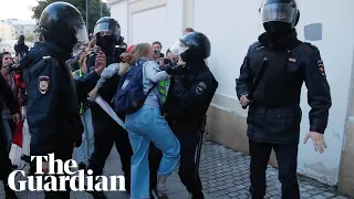 Riot police in Russia punch a women in stomach during a protest for free elections