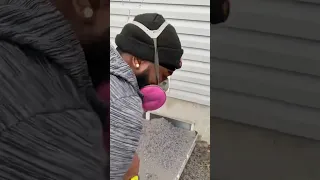 Man is cleaning a dryer vent from the outside of the house!