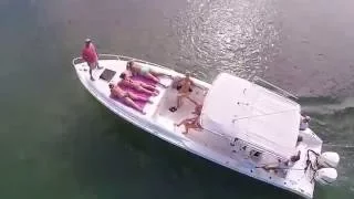 Girl flashes drone on boat