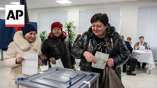 Russians vote in an election that holds little suspense after Putin crushed dissent