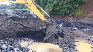 excavator working digging sand in sand mining - mountain slope