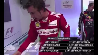 Fernando Alonso tosses Sebastian Vettel's cap