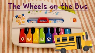 The Wheels on the Bus on a kids toy piano