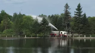 Fire Truck Spraying Water into the Canal